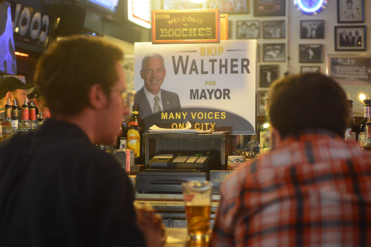 Two men enjoy a drink at Skip Walther's fundraiser